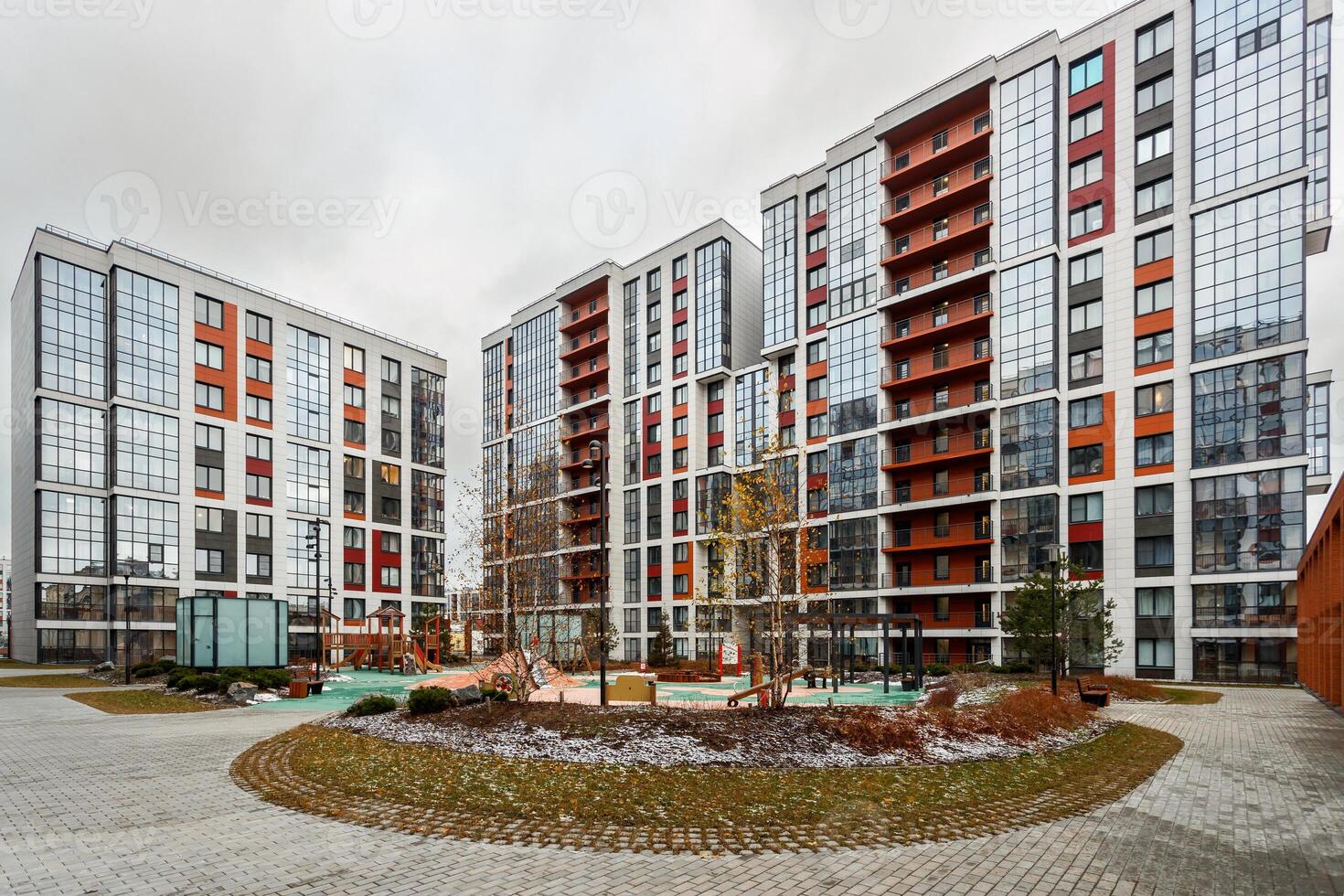 Architecture of a new residential quarter with a landscaped territory, view of a playground and building blocks. photo
