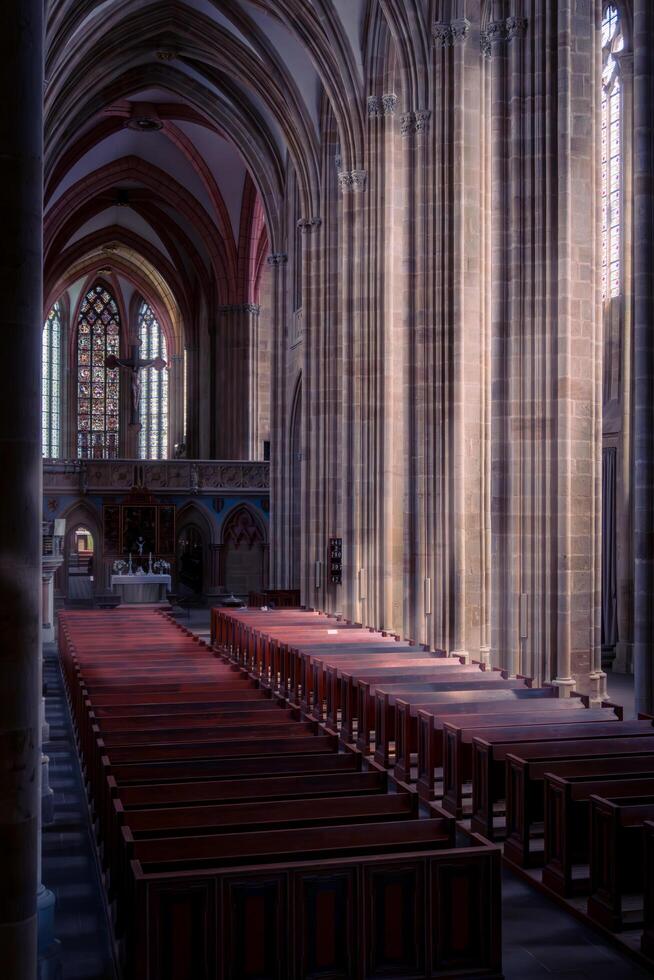 Meissen, Germany-august 17, 2022-central nave with tall columns, stained glass windows and altar of Meissen Cathedral on a sunny day photo