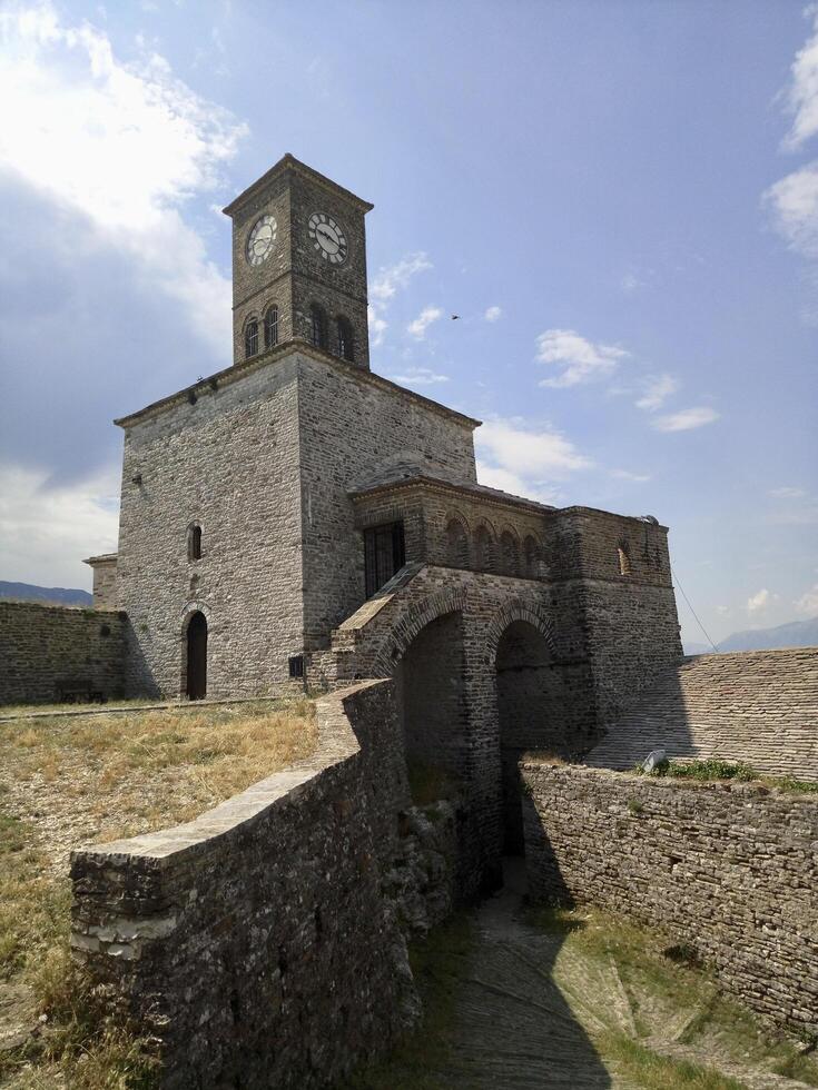 A large stone building with a clock tower photo
