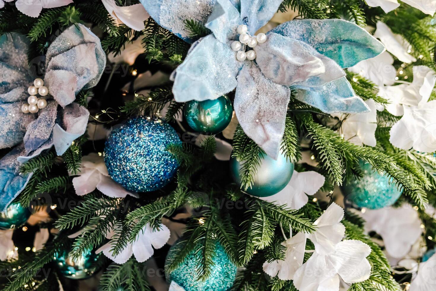 Holiday decorations with blue and white flowers adorning a festive tree in a cozy setting photo