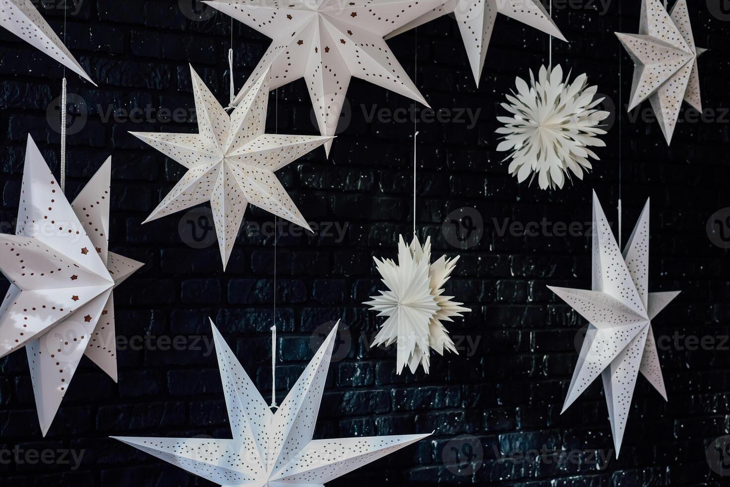 Hanging paper stars create a magical atmosphere in a cozy indoor space during the winter season photo