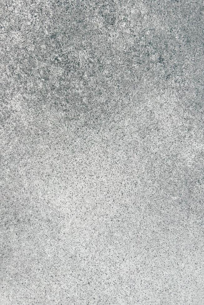 Gray textured surface with subtle variations in tone and pattern observed in natural light photo