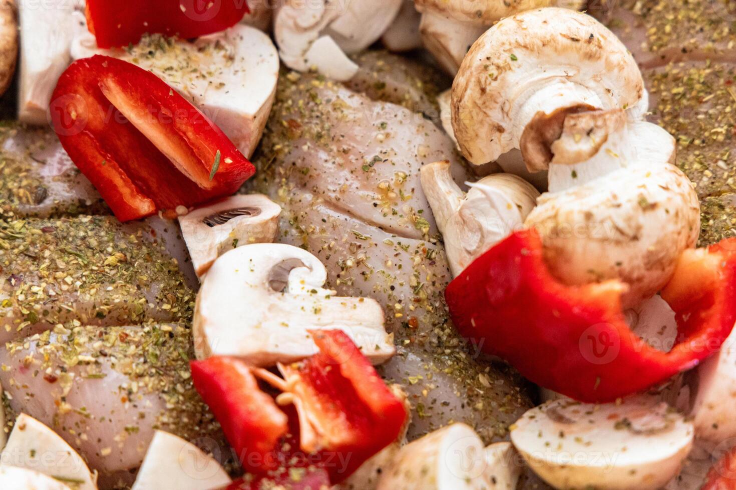 Preparation of marinated chicken with bell peppers and mushrooms for grilling during summer photo