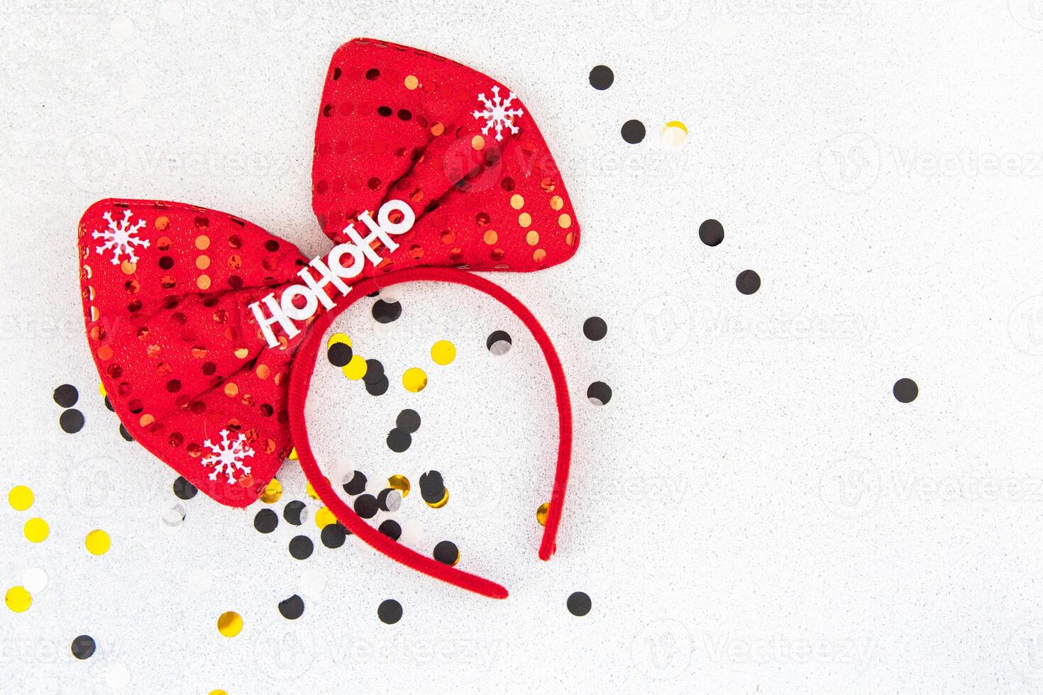 Festive red bow headband with holiday theme on a sparkling background photo