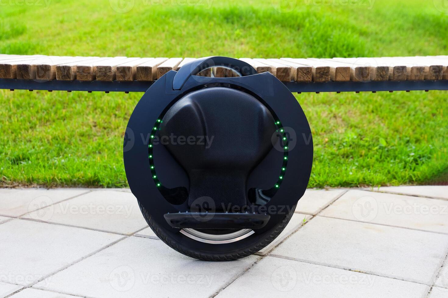 Innovative self-balancing electric unicycle parked on a walkway in a green park photo