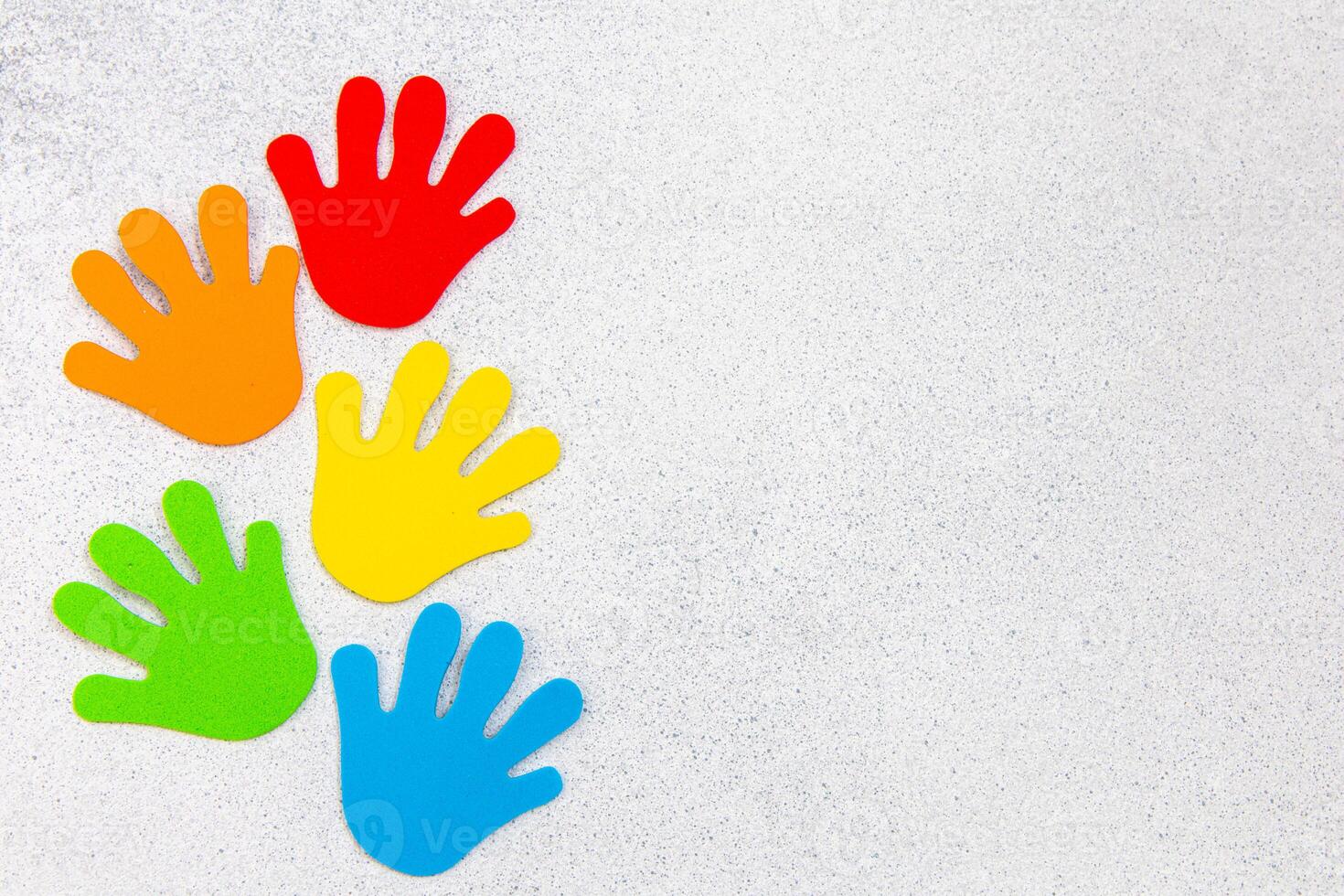 Colorful handprints arranged on a white background showcasing creativity and playfulness photo