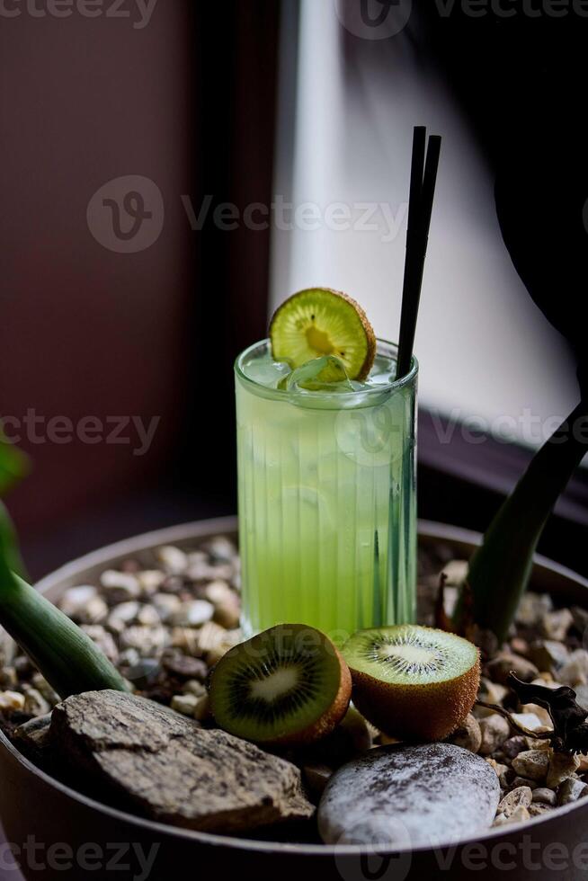 Kiwi juice in a glass on a wooden background. Selective focus. photo
