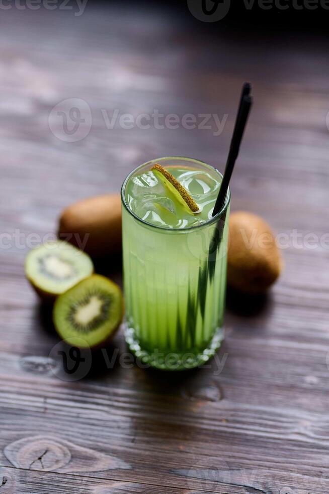 cocktail with kiwi and lime on a dark wooden background photo