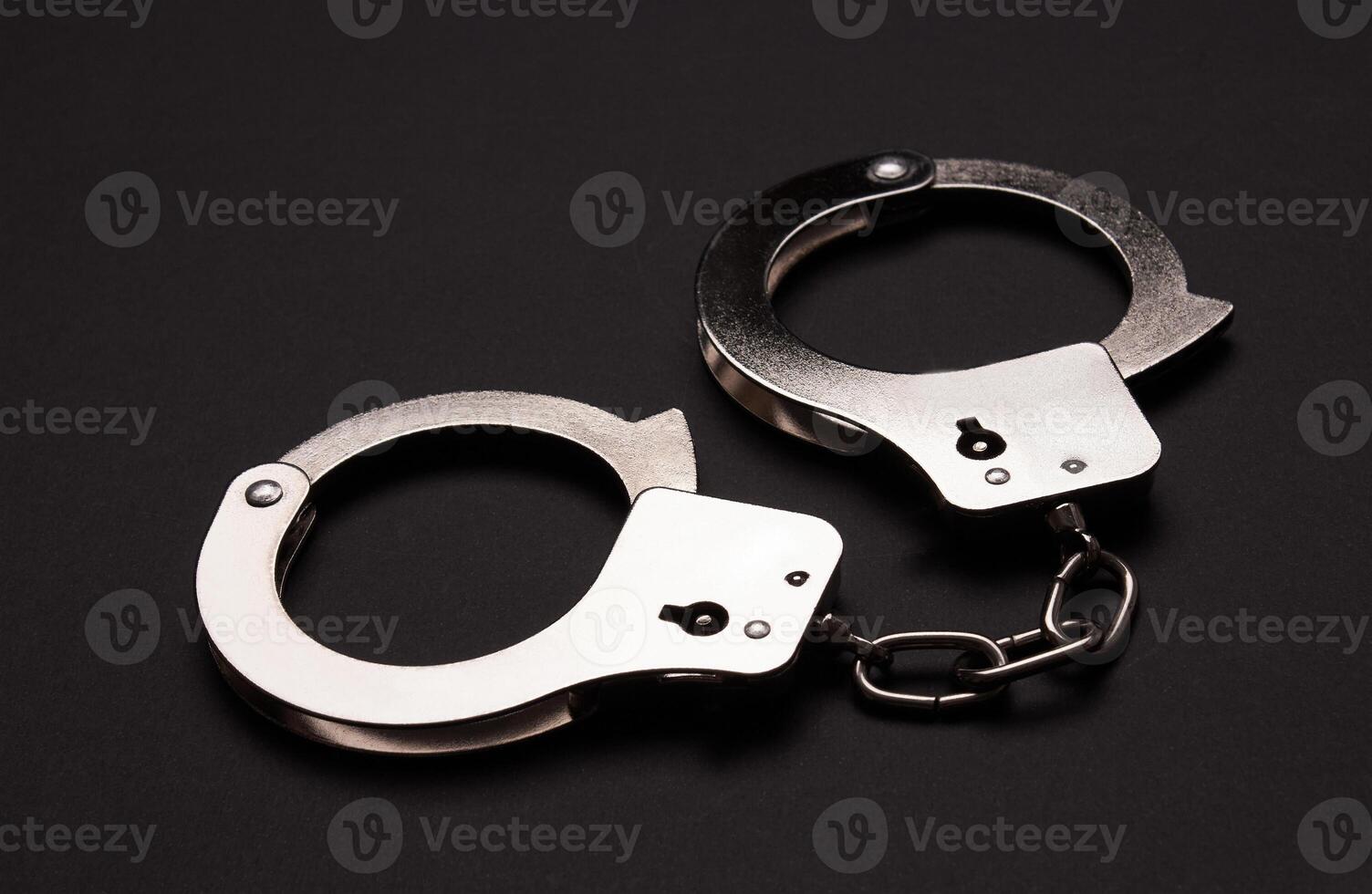 Handcuffs on black background photo