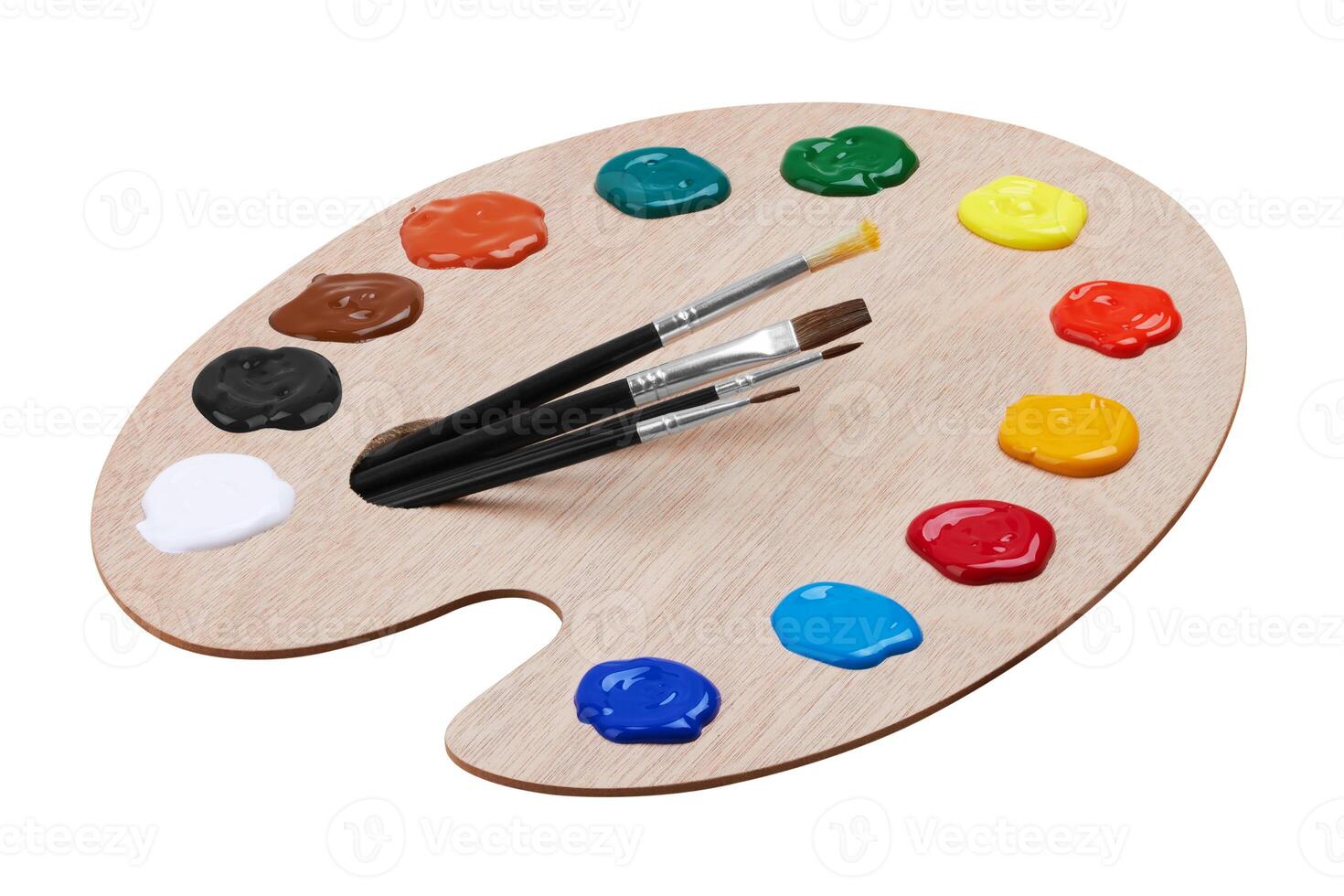 Wooden art palette with paints and a brushes photo