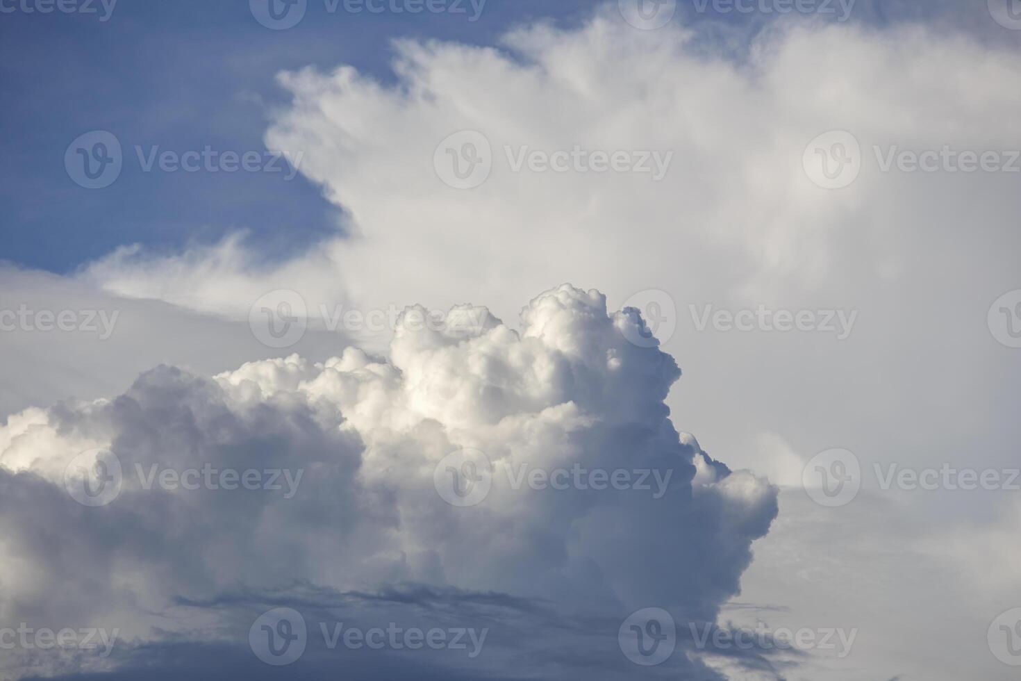 White clouds form in the blue sky before the rain begins to fall. photo