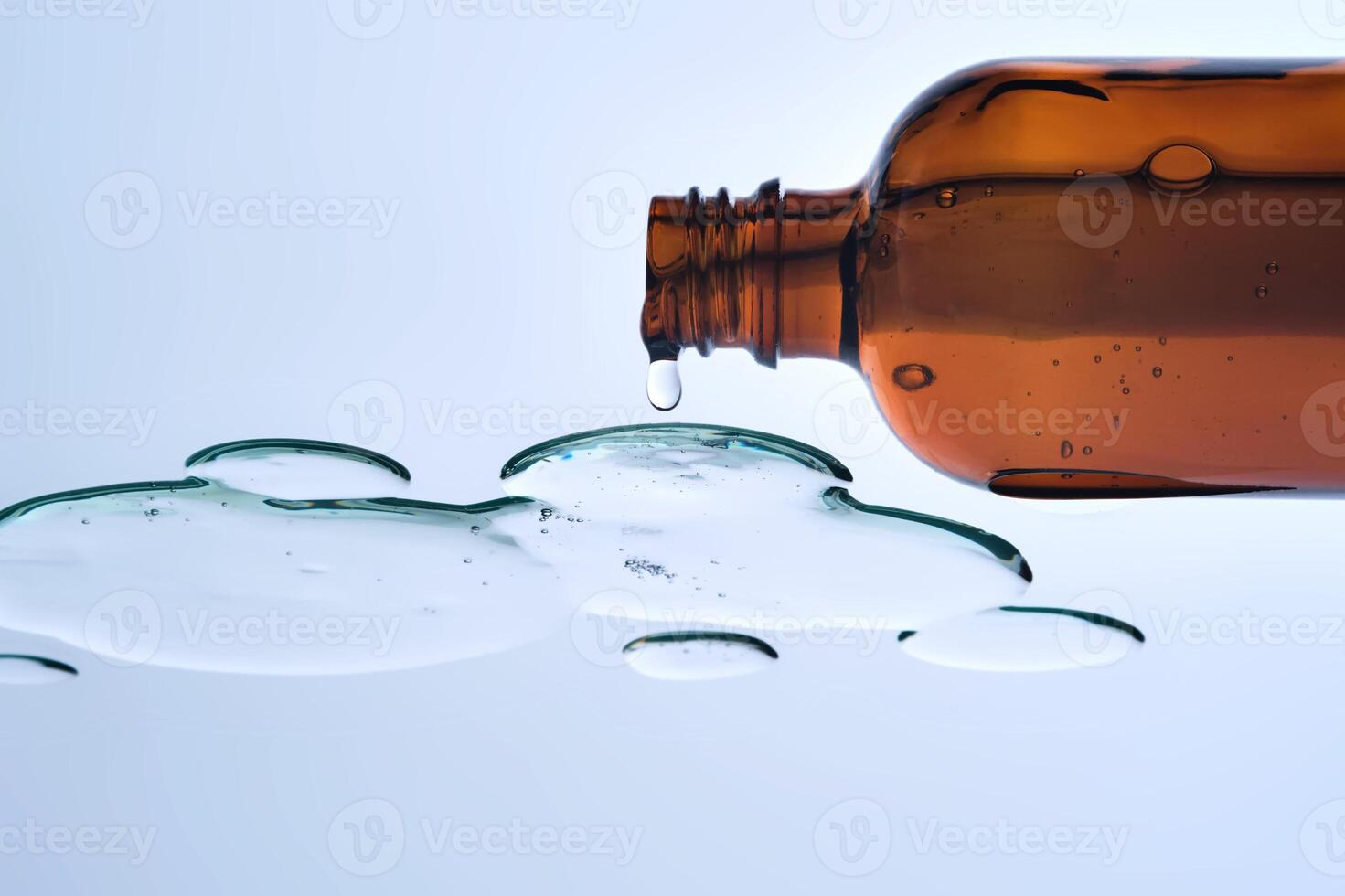 A bottle of cosmetic product with a serum texture. View from below. photo