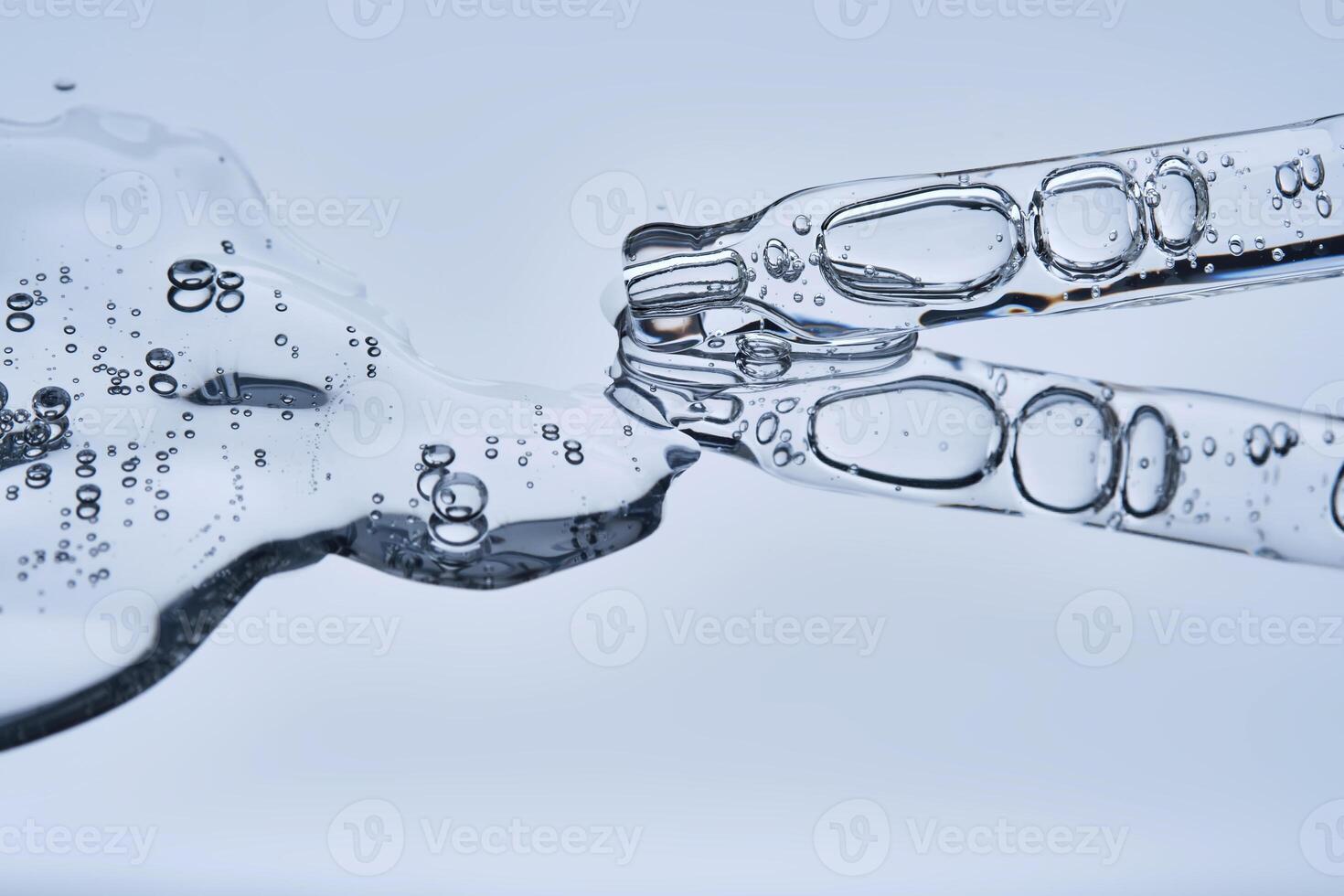 The texture of serum with spicules in a dropper on a blue background. photo
