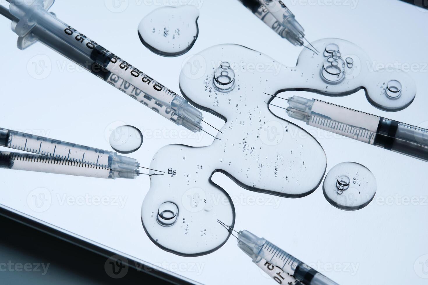 Syringes for injection and a drop of the drug in the tray. photo