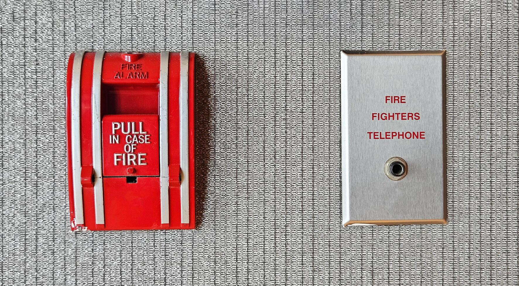 Fire alarm switch box and firefighter telephone port for connect or calling on gray background Device or tool for pull out in case of fire and prevent emergency event and Protect concept. photo
