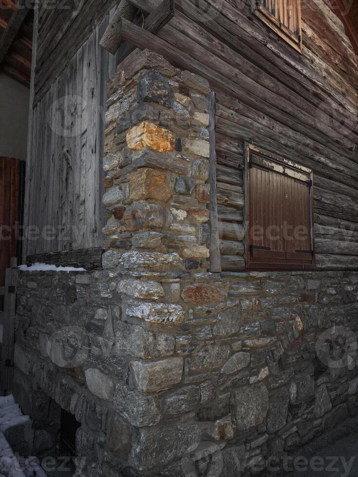 Close up of traditional stone and wood structure in aosta, italy, showcasing rustic architectural details and textures in a november setting Lillaz photo