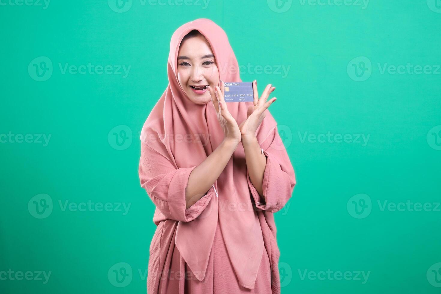 Delighted muslim woman showcasing her new credit card for cashle photo