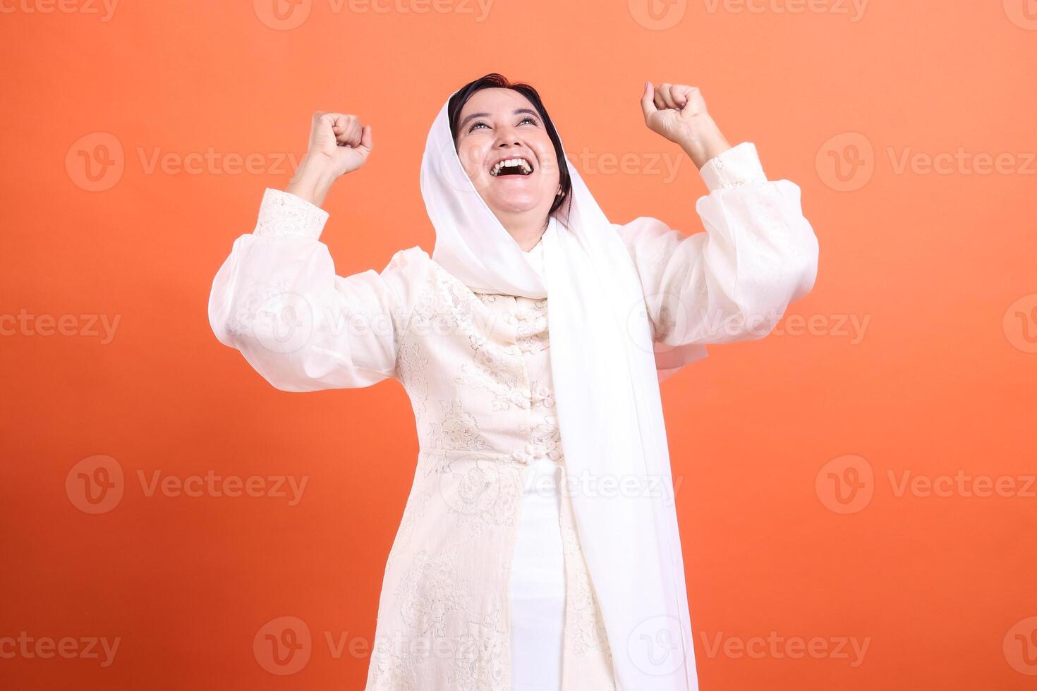 Victorious woman in traditional attire exudes joy and triumph, r photo
