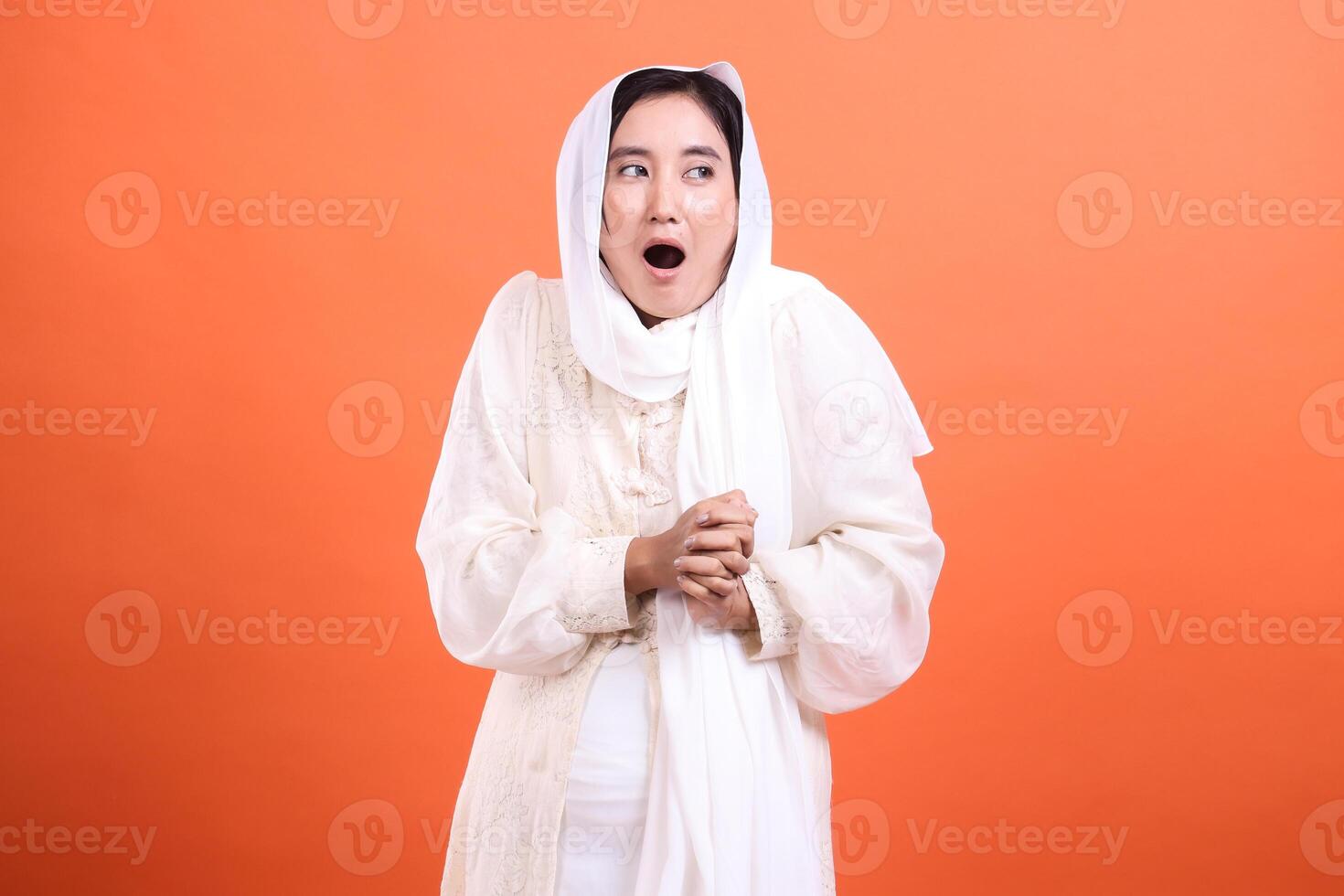 Astonished Muslim Woman in Traditional Attire, A moment of delig photo