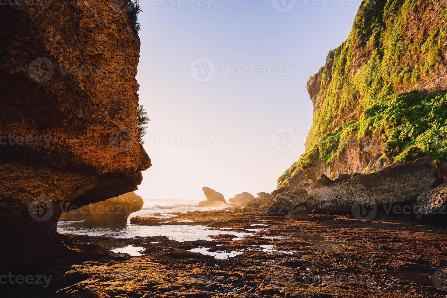 Cliff with rocks, stones, ocean and sunset tones in Bali, Uluwatu photo