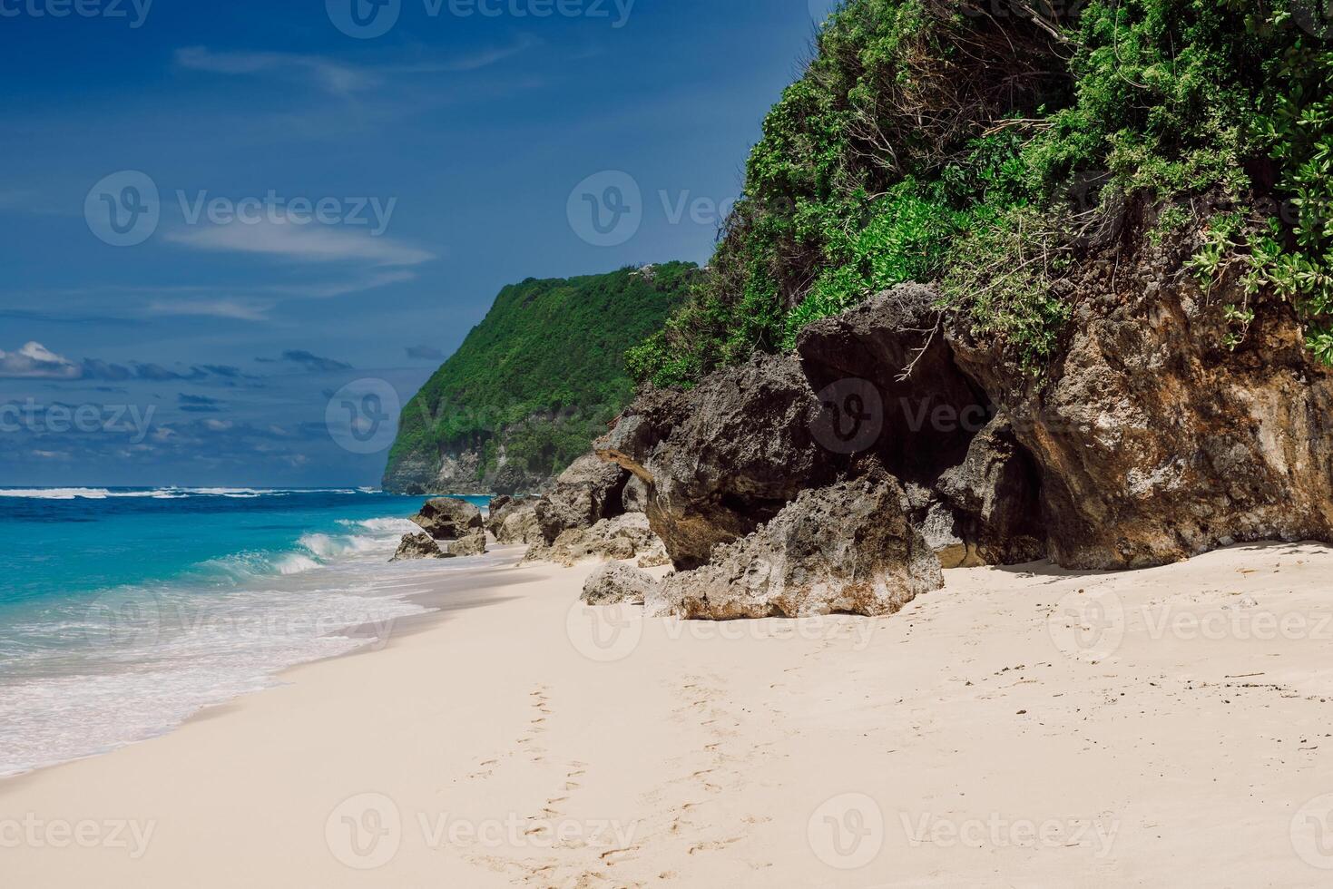 Tropical sandy beach with blue ocean in tropical island photo