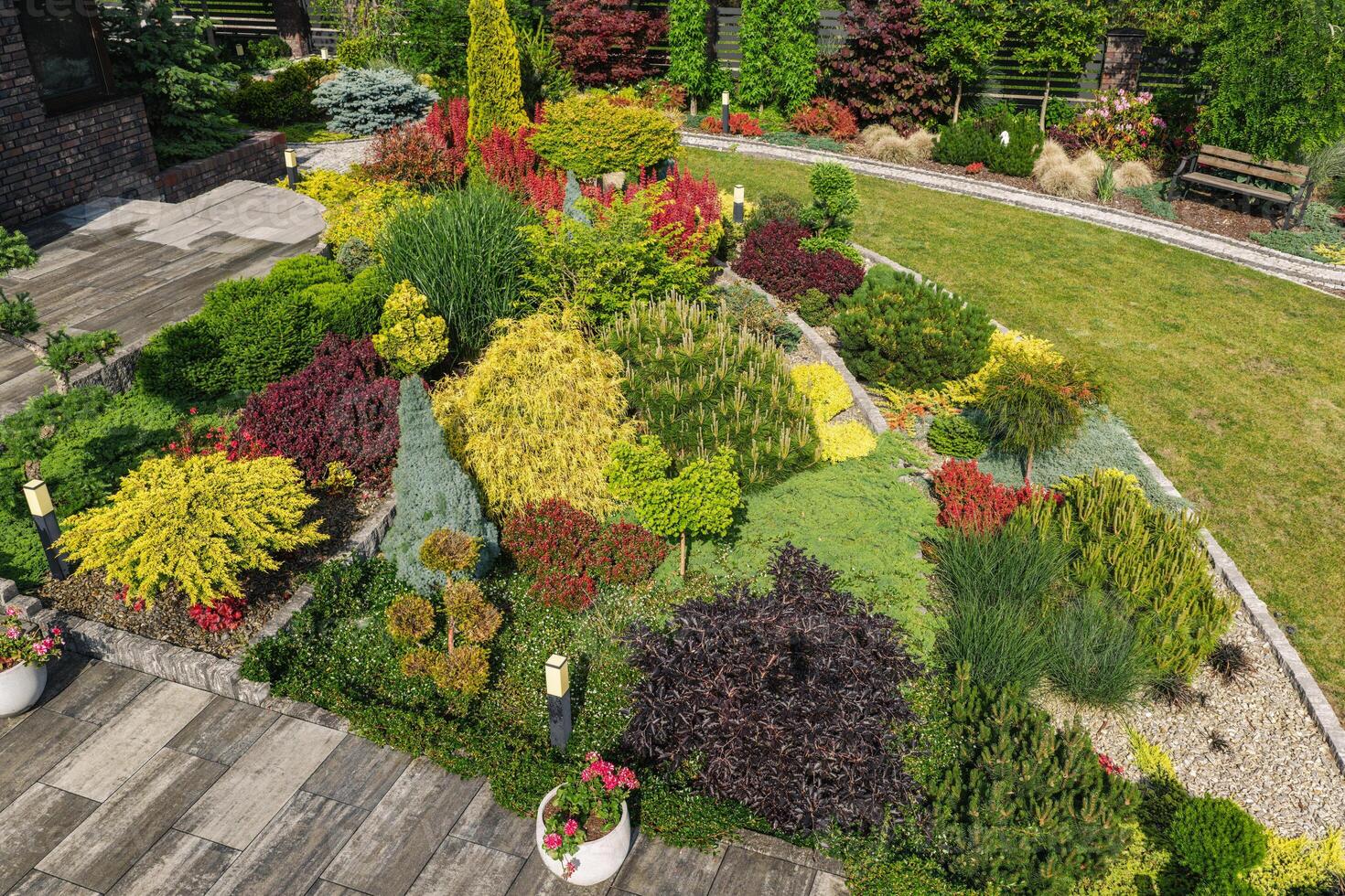 Vibrant Garden Design Showcases a Variety of Colorful Plants in a Landscaped Setting photo