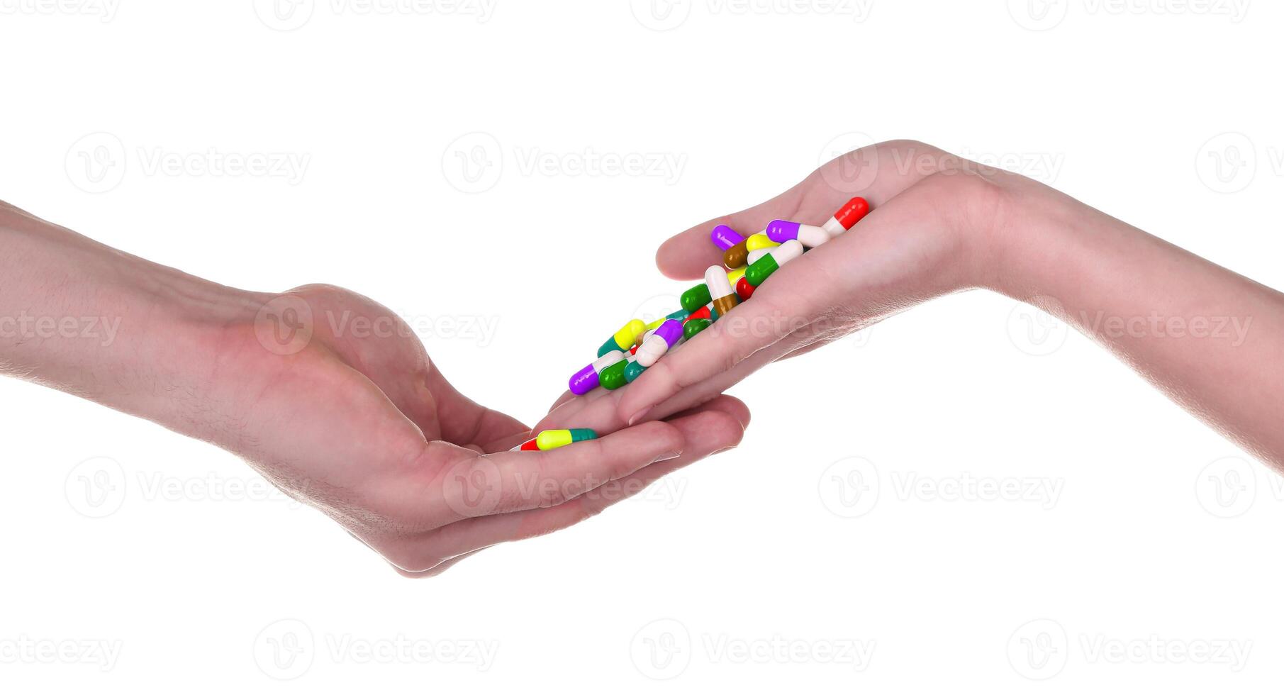 Two hands holding colorful pills photo