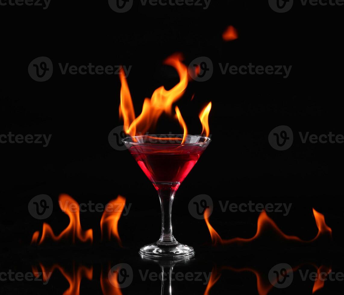 A red cocktail with flames on the glass photo
