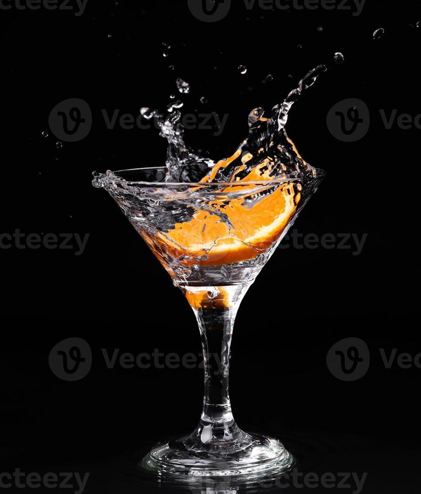 A splash of water on a glass of orange juice photo