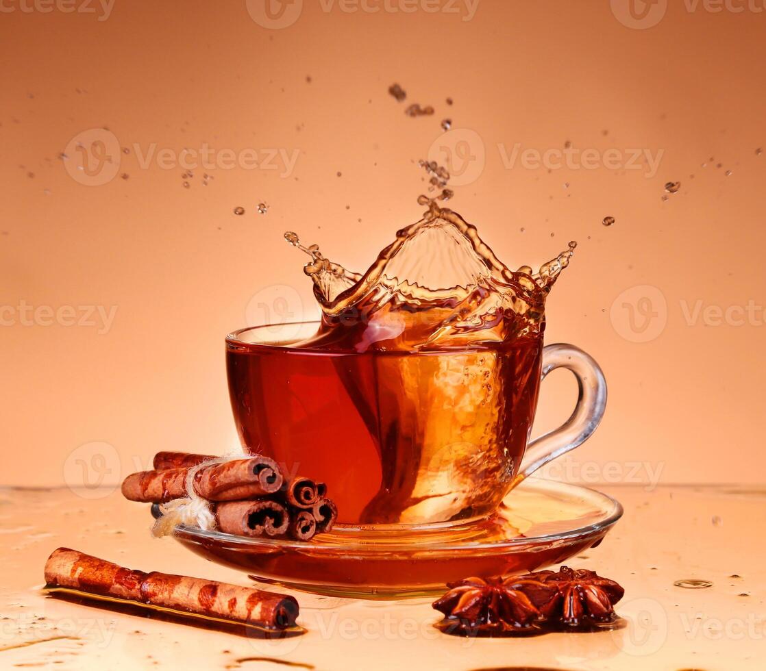 A cup of tea with cinnamon and cinnamon sticks photo