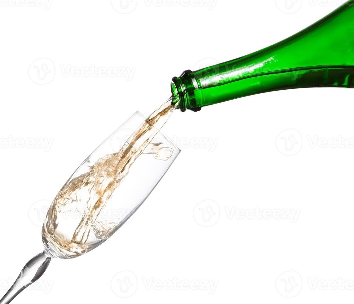 A bottle of champagne being poured into a glass photo