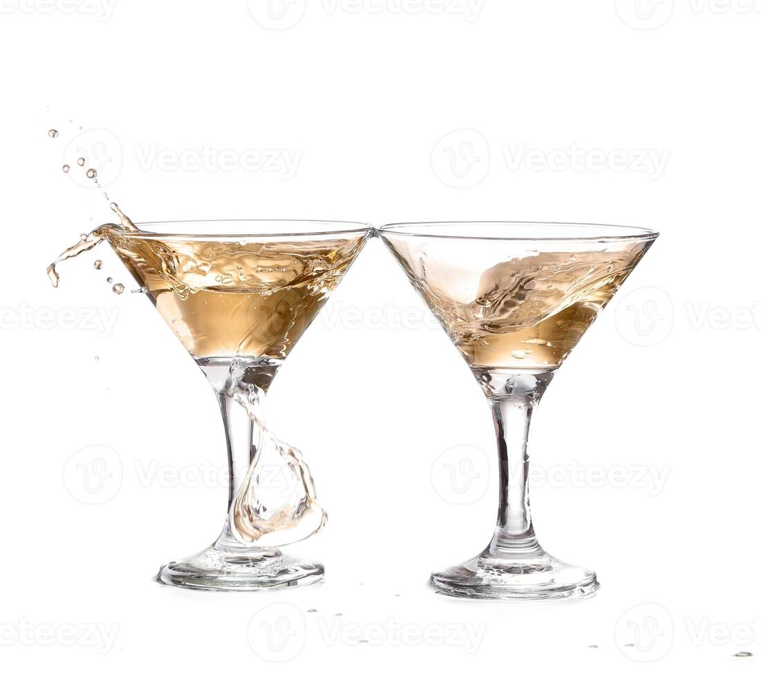 Two martini glasses with liquid splashing into them photo