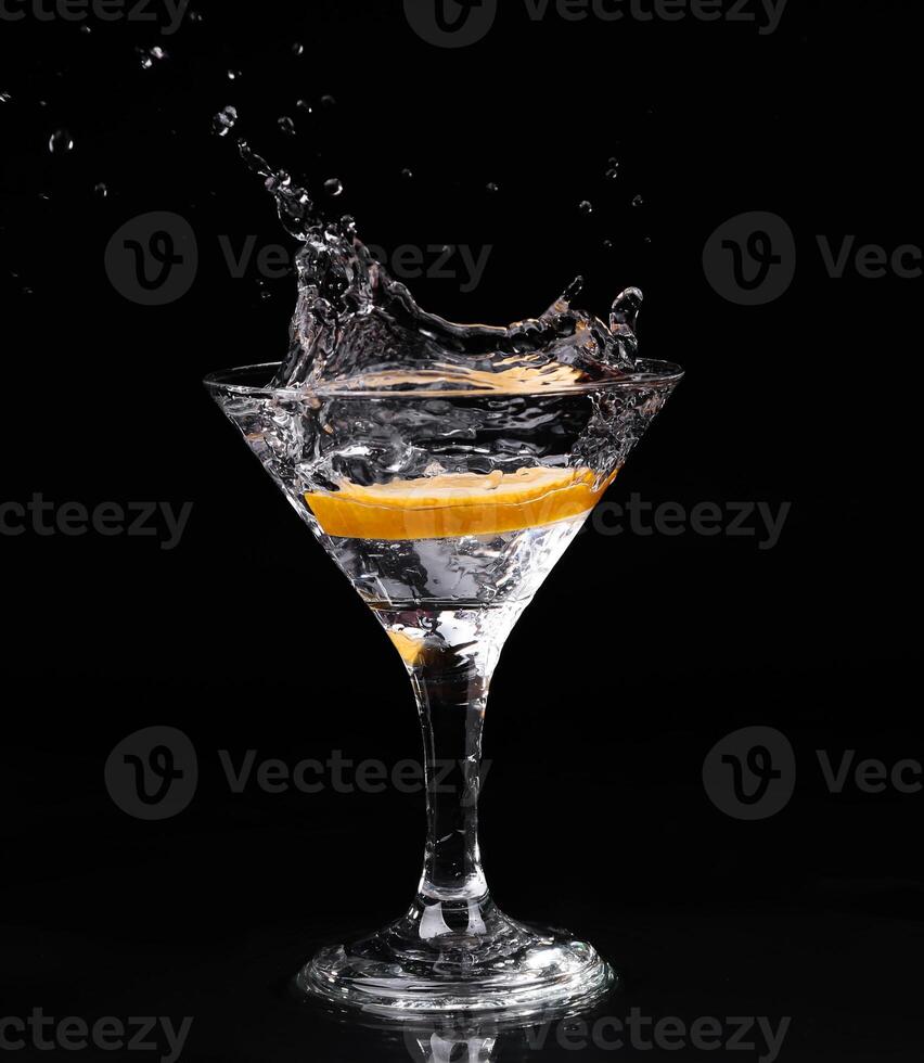A martini glass with a splash of water photo