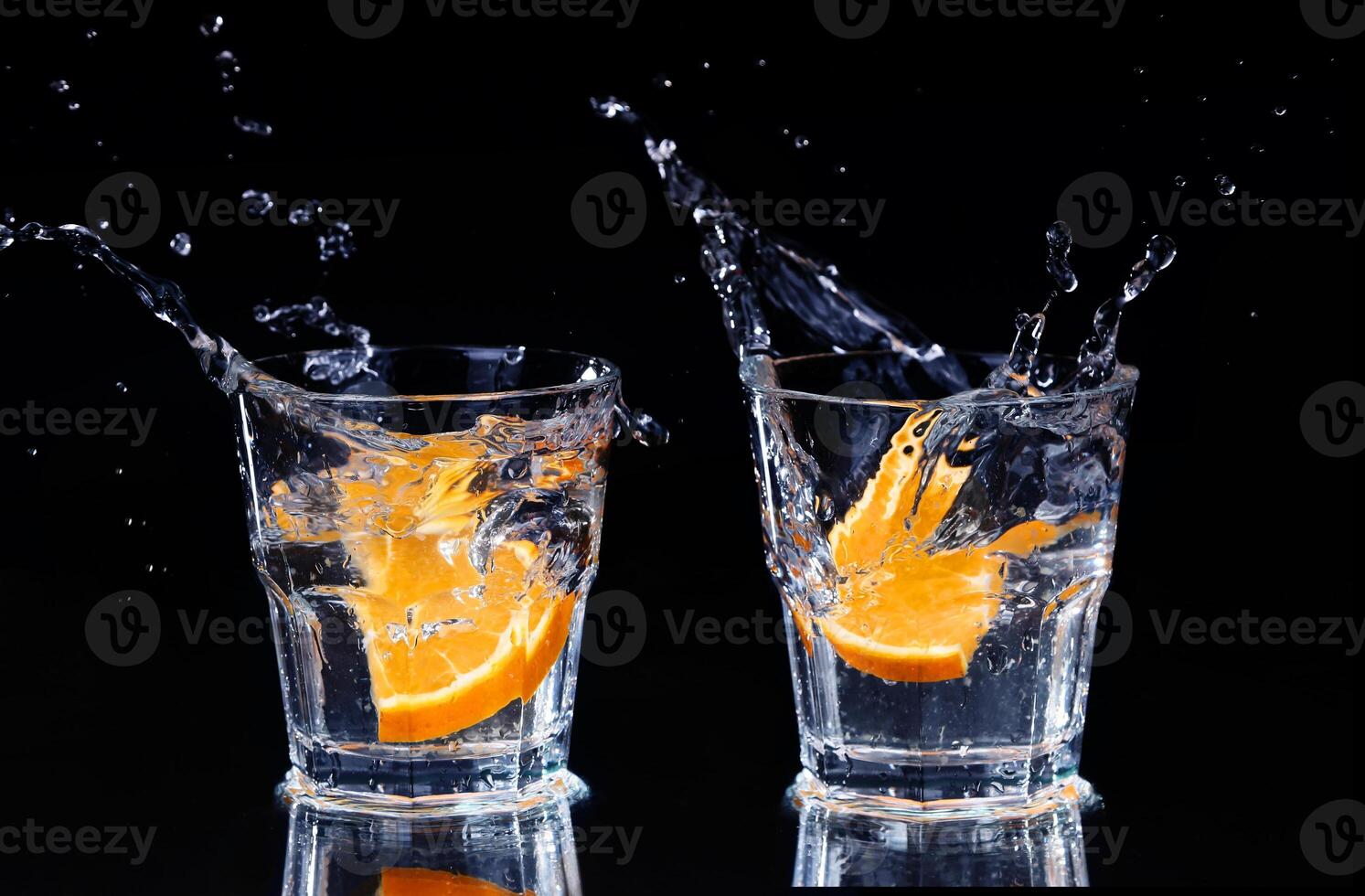 Two glasses with water and an orange slice photo