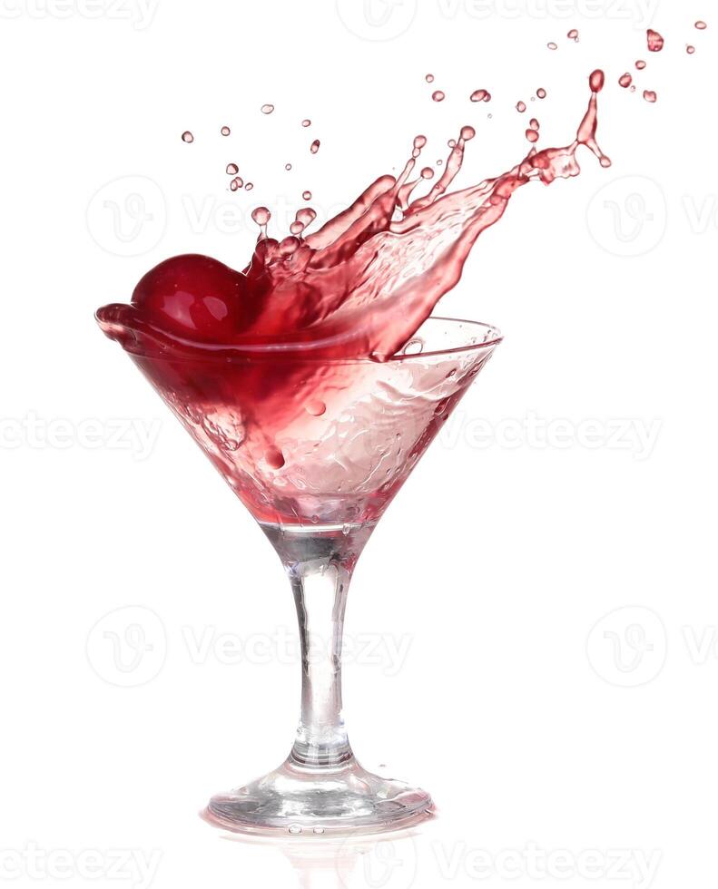 A cherry being splashed into a martini glass photo