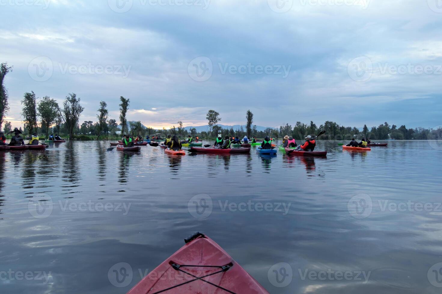 Kayaking at sunrise on a tranquil lake offers a peaceful outdoor experience photo