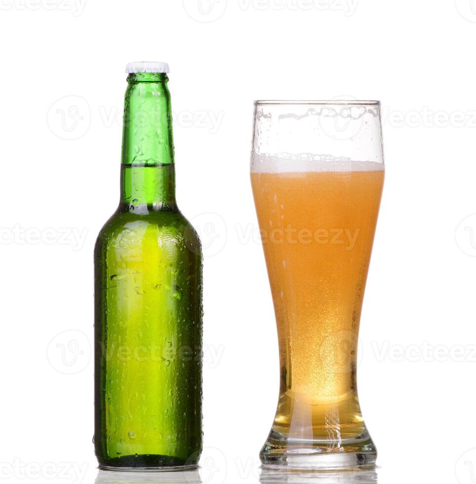 A beer bottle and a glass of beer on a white background photo