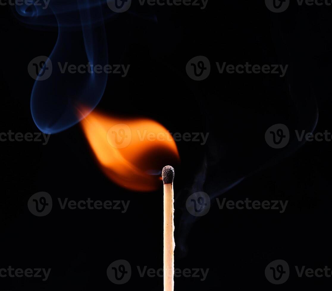 A matchstick with a flame and smoke photo