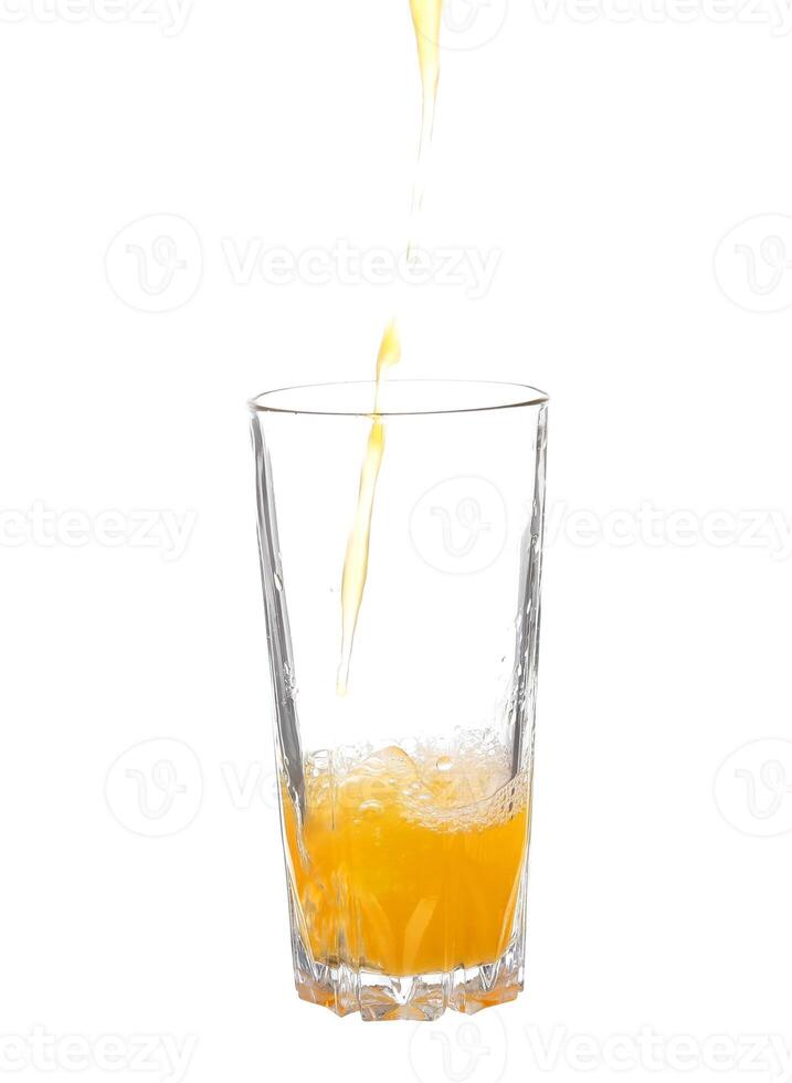 Orange juice being poured into a glass photo
