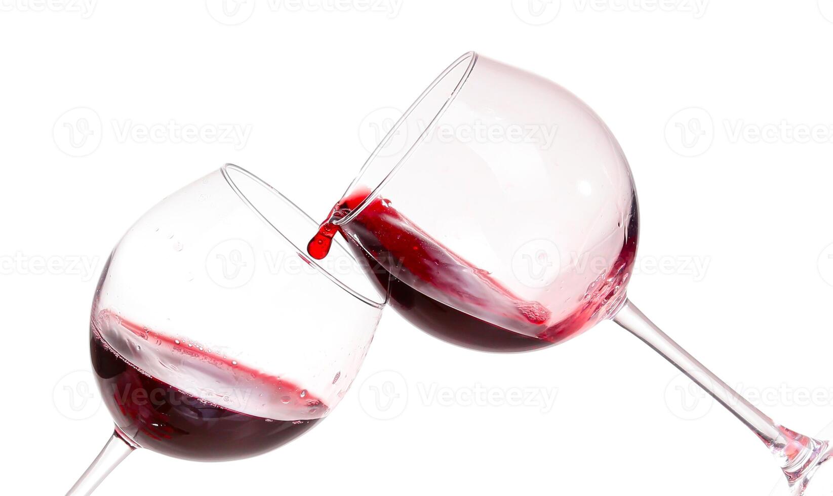 Two wine glasses with red liquid being poured into them photo