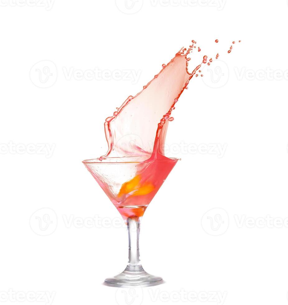 A splash of red liquid in a martini glass photo