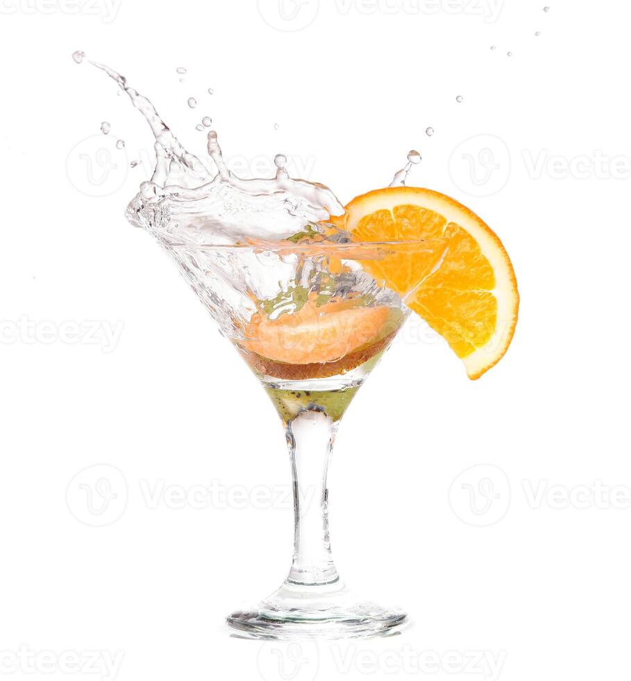 A martini with an orange slice and water splashing photo