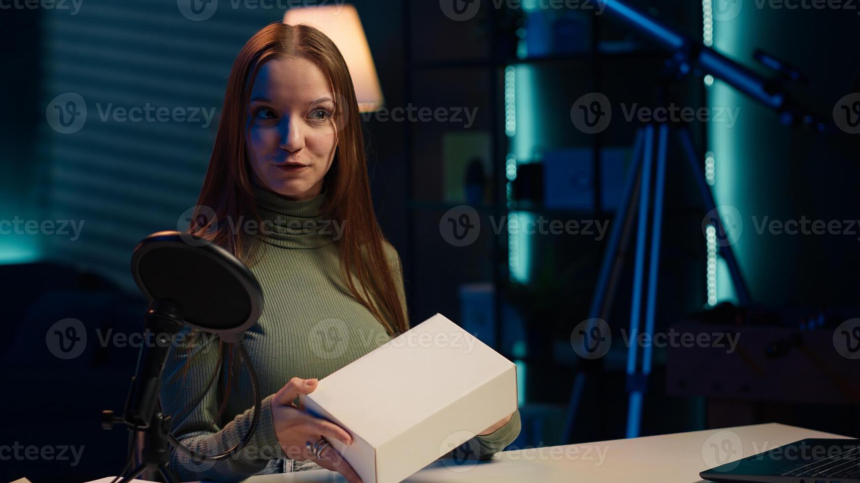 Content creator filming technology review of various electronics, unboxing and presenting features to audience. Influencer showing product recommendations to followers on social media, camera A photo