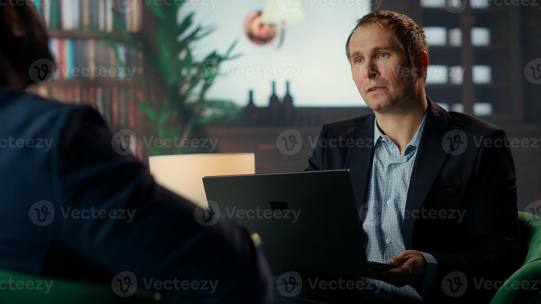 secret service agent in a classy headquarters library, briefing each other on critical mission case details over whiskey glasses. Professional intelligence bureau spies. Camera B. photo