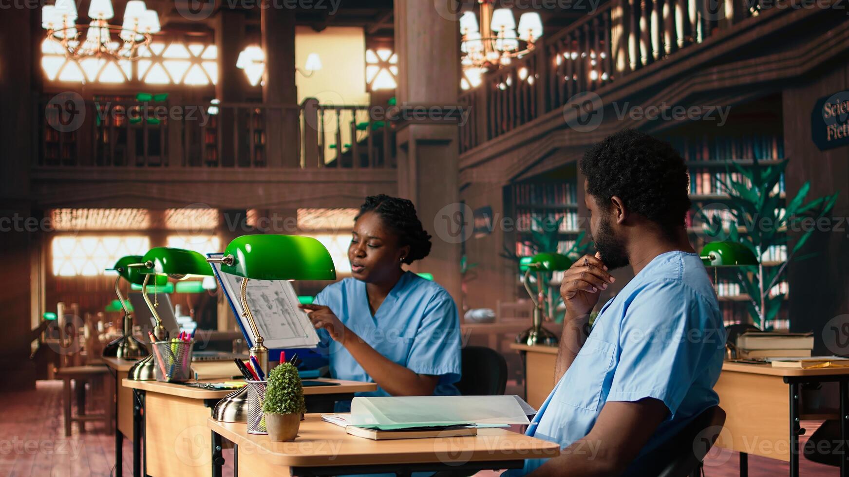 African american nurses in training review medical school papers and class notes, learning together and preparing for tests in campus library. Healthcare practice for medical career. Camera A. photo