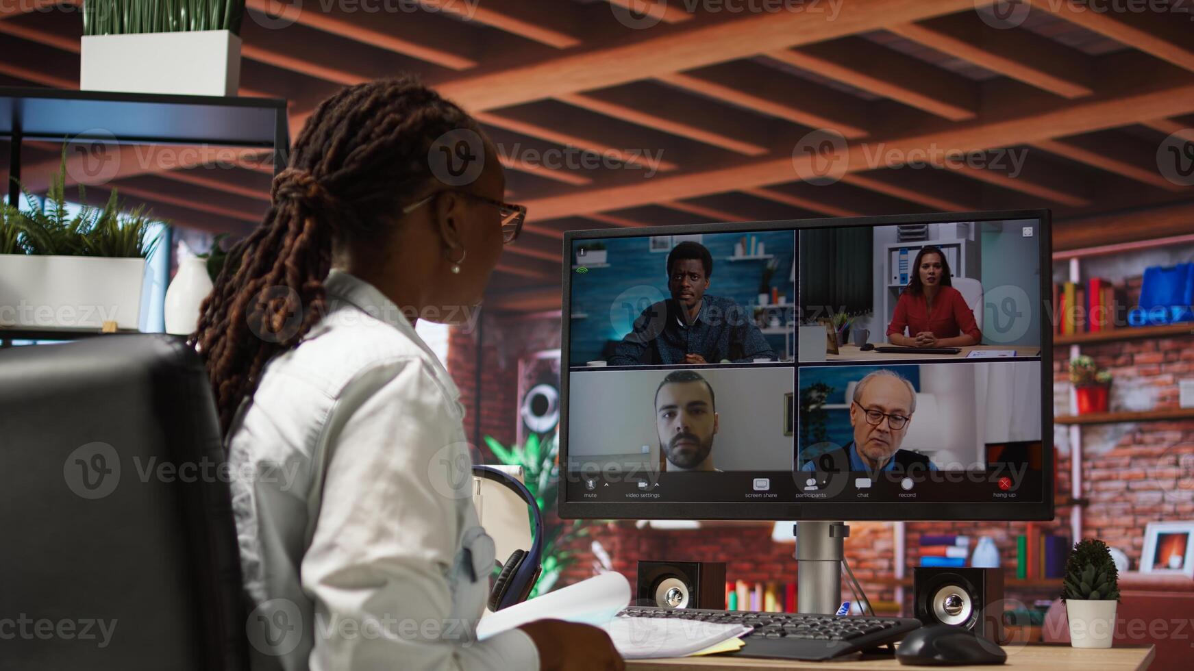 Manager greeting employees during videocall from home, looking over paperwork, organizing job shifts. Supervisor doing remote teleconference meeting with staff, checking documents, camera A photo