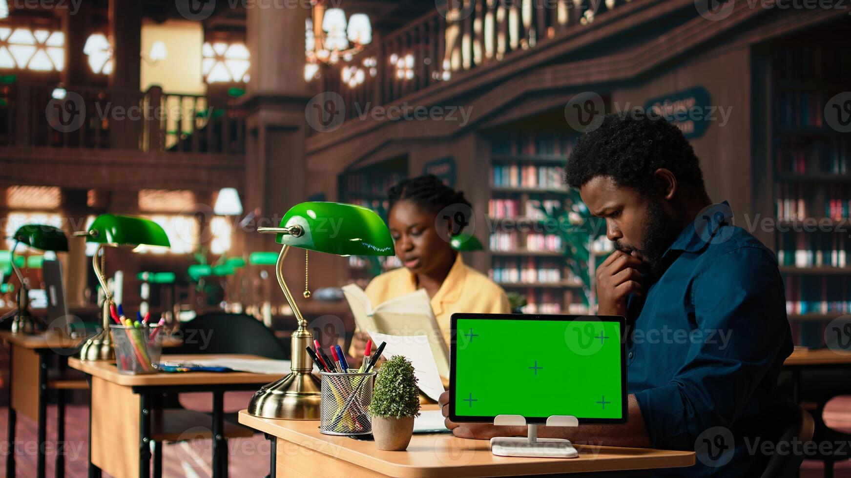 African american students checking research papers next to green screen from academic database, learning information from copy books. Young team of pupils at library. Camera A. photo