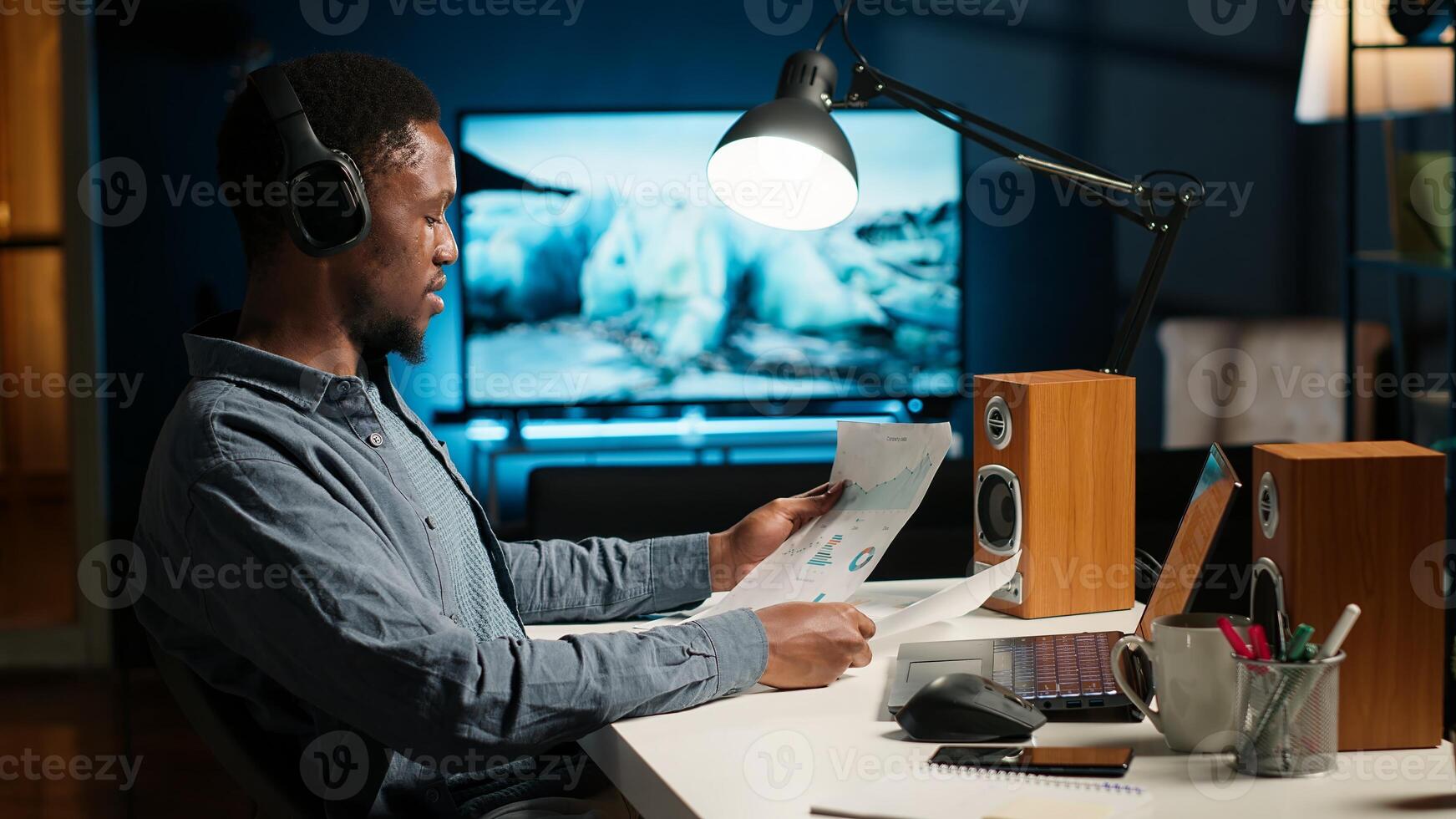 advisor talks to his team on phone call at home office, obtain new business funding from shareholders. Young man doing remote work to increase revenue and reduce cost. Camera B. photo