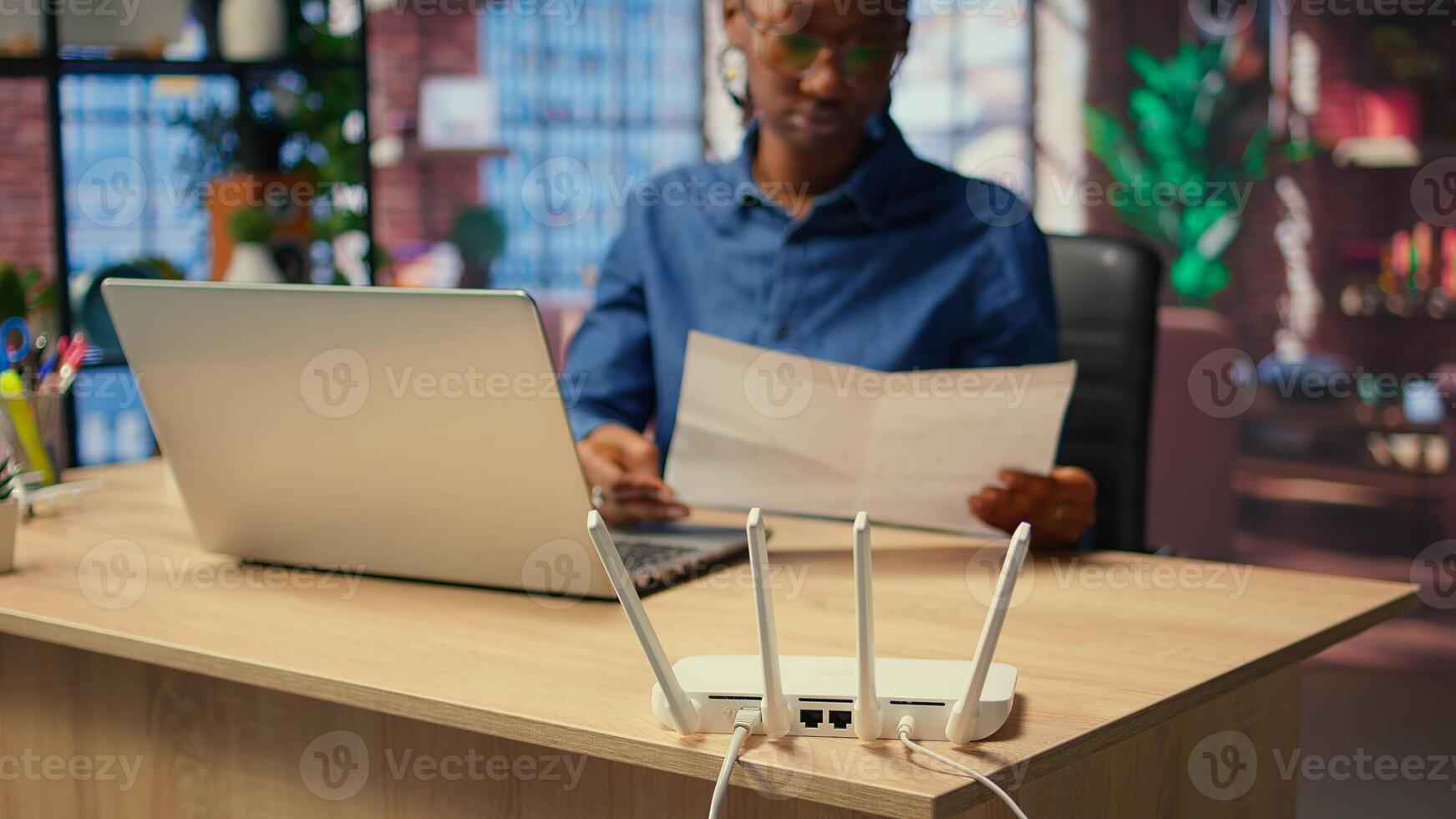 Young woman struggling with weak internet connection at home, pulling out LAN cable and adjusting Wi Fi settings to restore signal. Female freelancer with technical issues. Camera A. photo