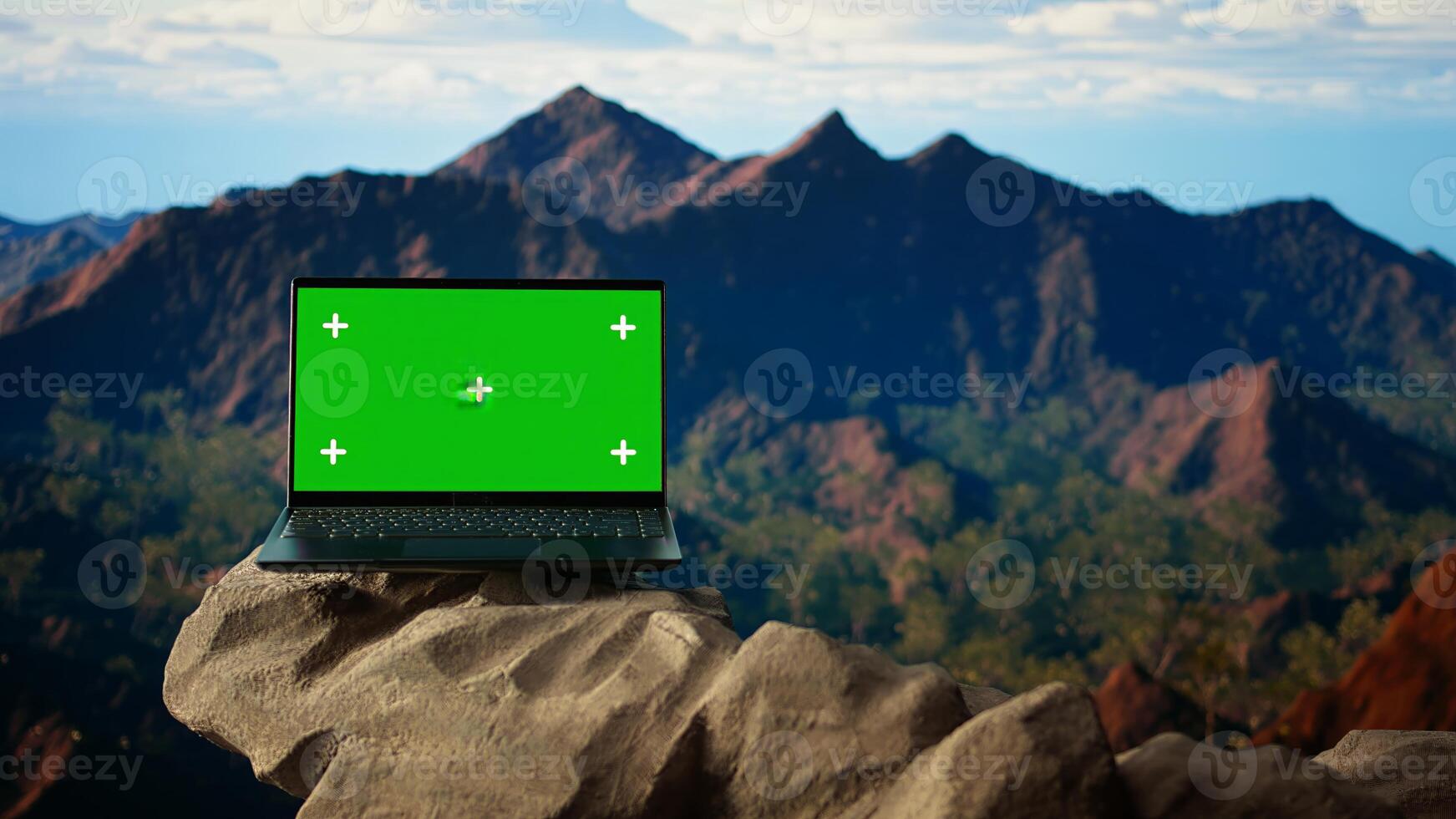 Dramatic mountain range stretches across horizon with green screen laptop, offering spectacular views for hikers and adventurers. The rugged terrain is a challenge worth conquering. photo